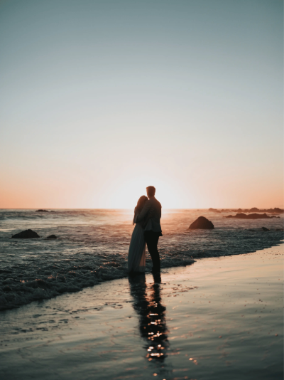 A man and a woman are watching the sunset
