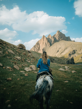 Woman on a horse in the mountains