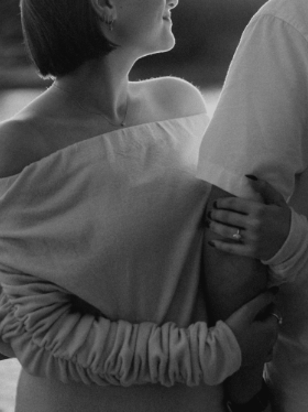 A woman holding a man in an embrace